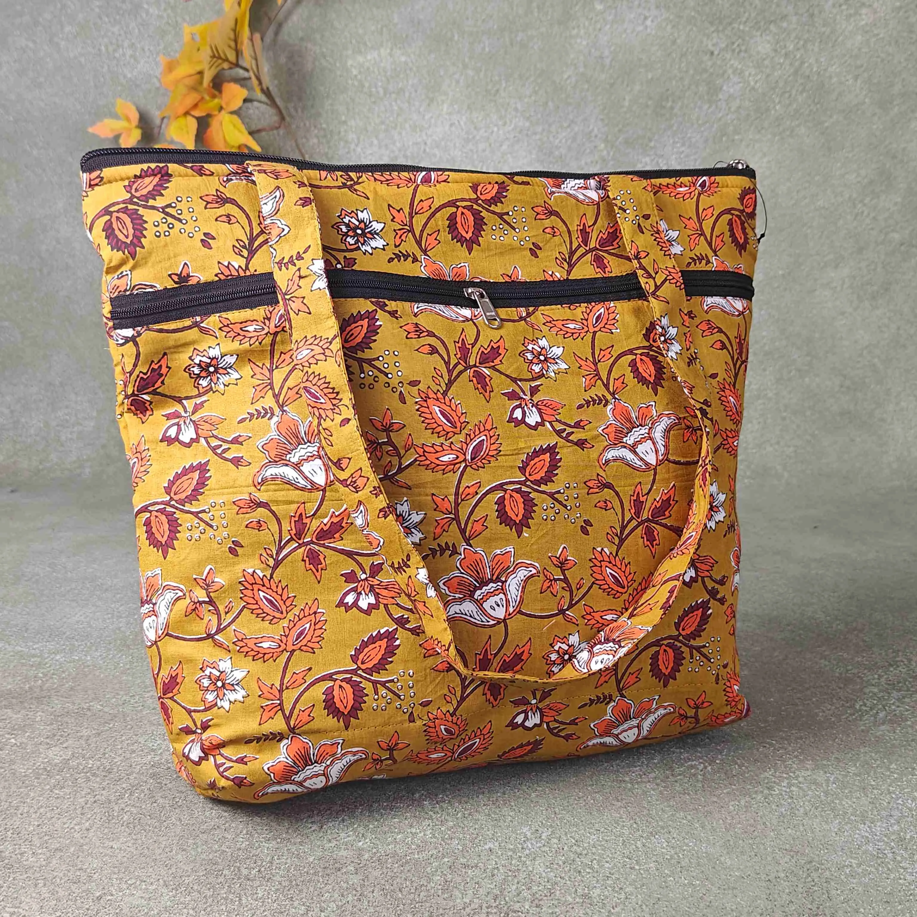 Medium Size Handbag Yellow Colour with Brown and orange Design Prints.